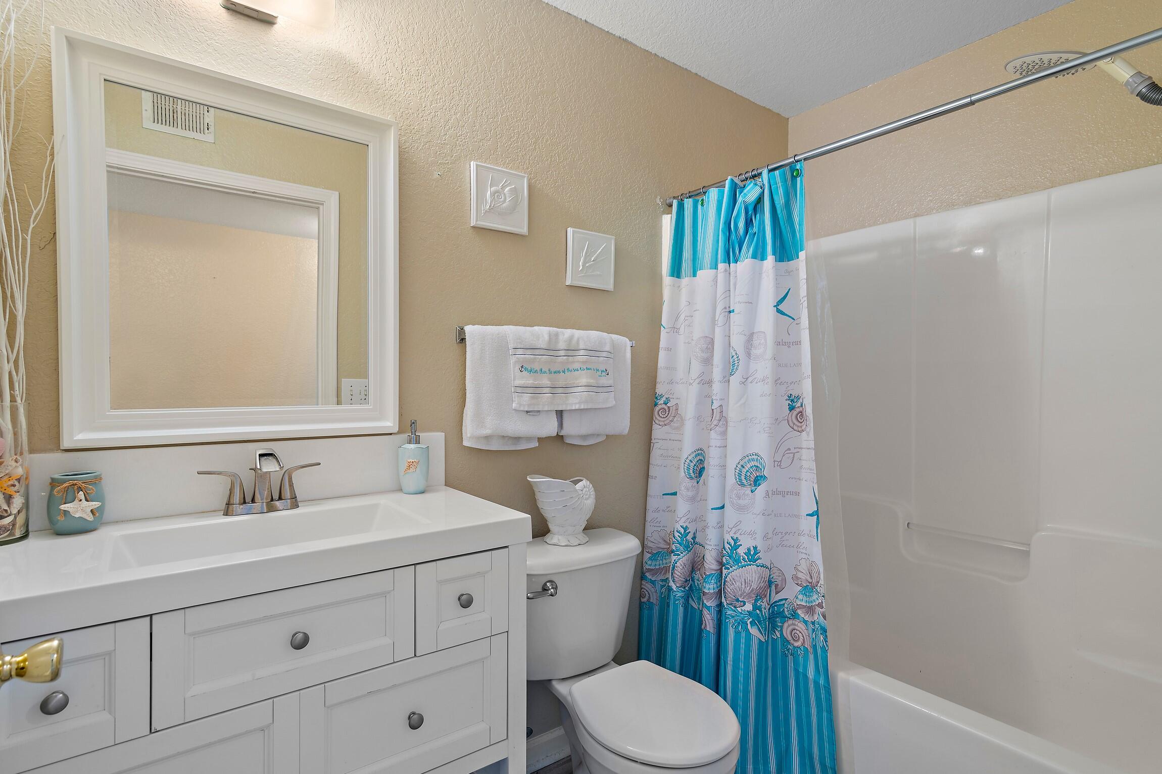4010 Dancing Cloud Court, Unit 404 Destin, FL 32541 - Photo 5 of 44 a bathroom with a sink a toilet and shower