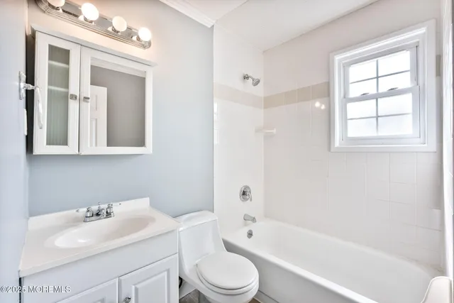 a bathroom with a sink toilet tub and shower