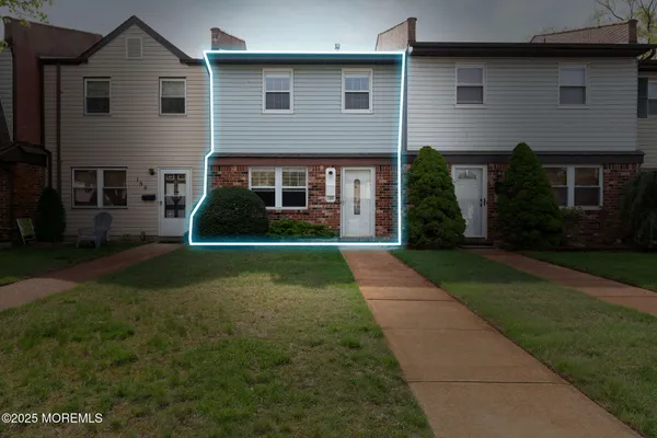 a view of house in front of a yard with potted plants