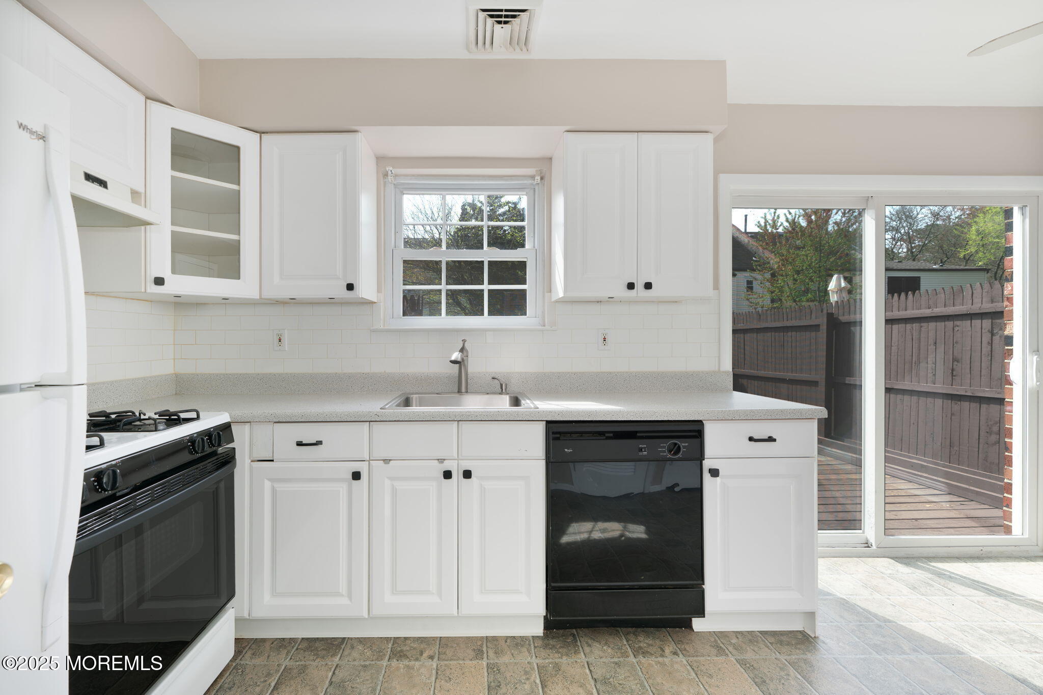 156 Greenwood Loop Road Brick, NJ 08724 - Photo 8 of 22 a kitchen with white cabinets and a stove