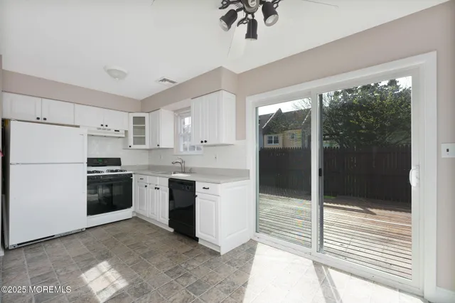 a kitchen with a refrigerator and a stove