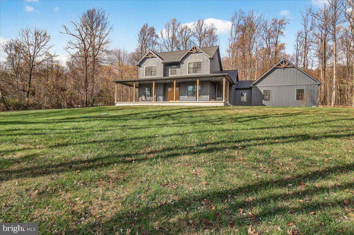 16080 Kelbaugh Road Thurmont, MD 21788 - Photo 3 of 56 a front view of a house with a garden