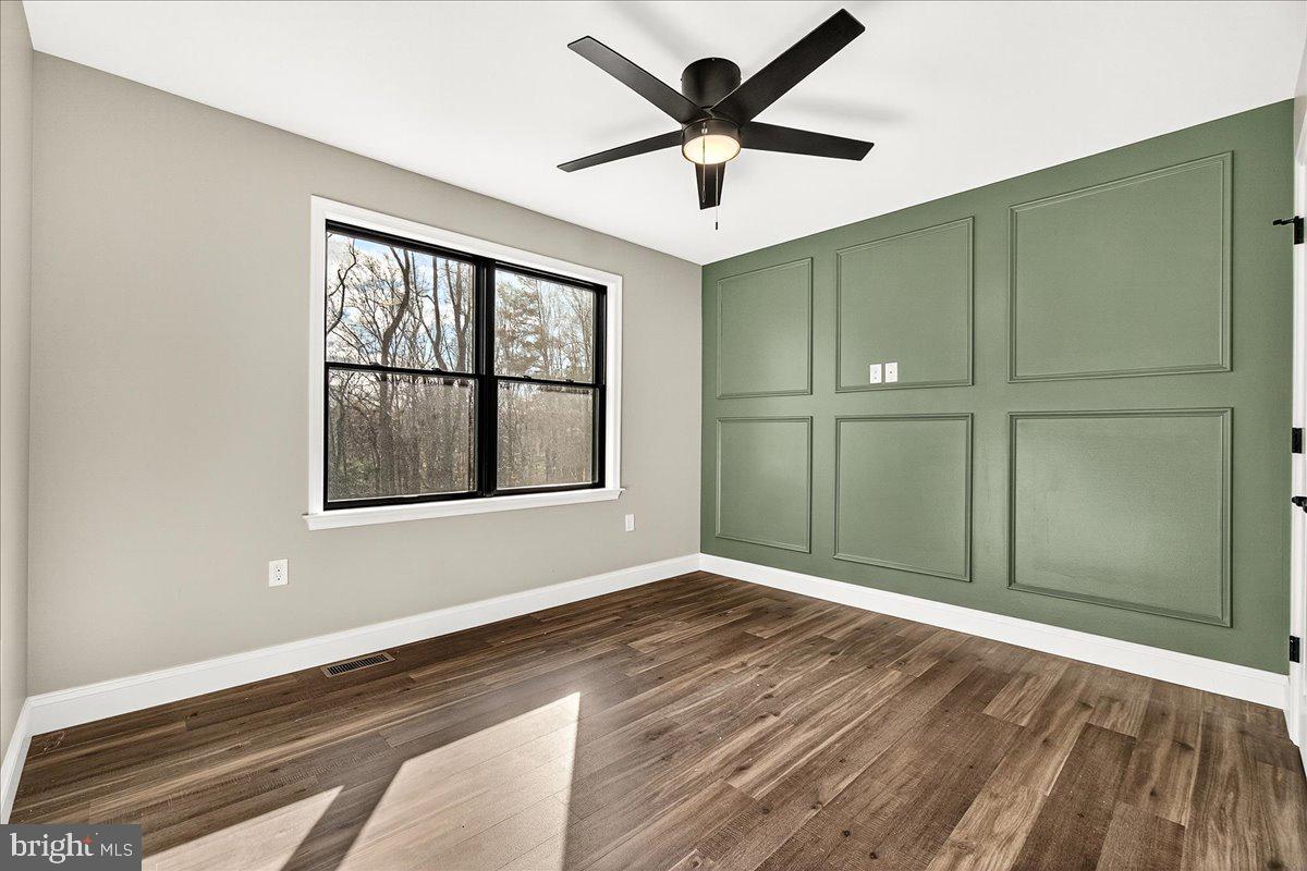16080 Kelbaugh Road Thurmont, MD 21788 - Photo 35 of 56 an empty room with wooden floor and windows