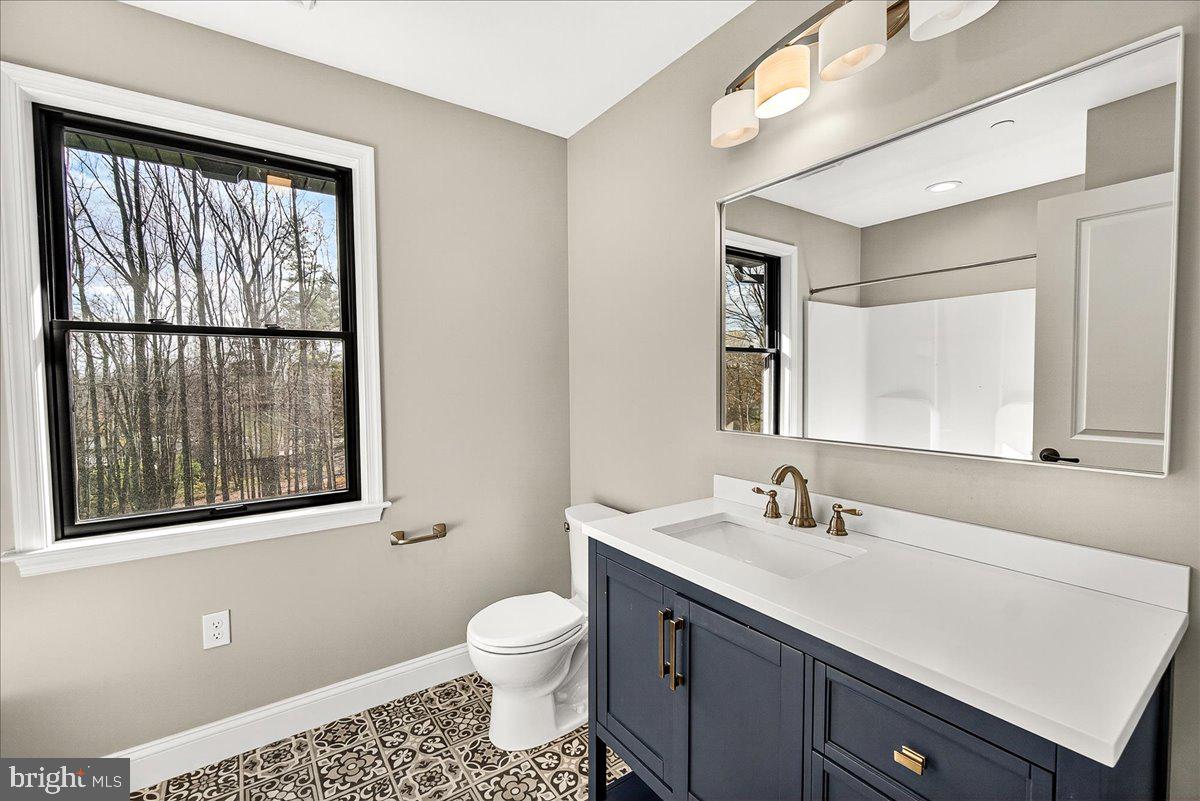 16080 Kelbaugh Road Thurmont, MD 21788 - Photo 36 of 56 a bathroom with a toilet sink vanity and mirror