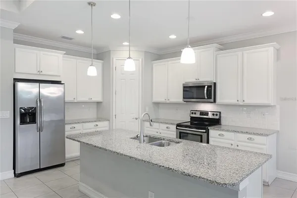 a bathroom with a granite countertop sink a large mirror and a shower