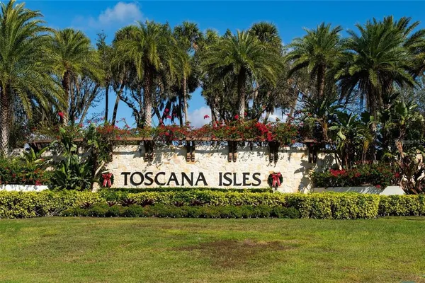 a front view of a house with a garden and lake view