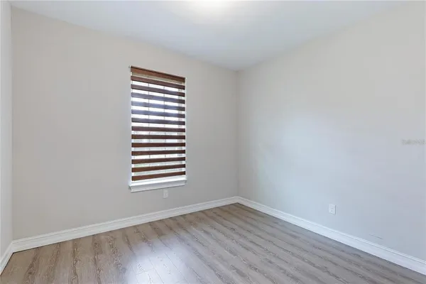 an empty room with wooden floor
