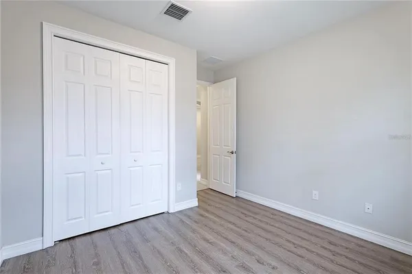 a bathroom with a granite countertop sink toilet tub vanity and shower