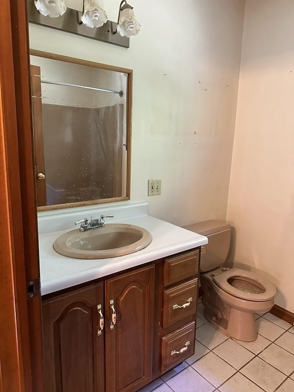 179 Mixter Road Holden, MA 01520 - Photo 6 of 8 a bathroom with a sink a toilet and mirror