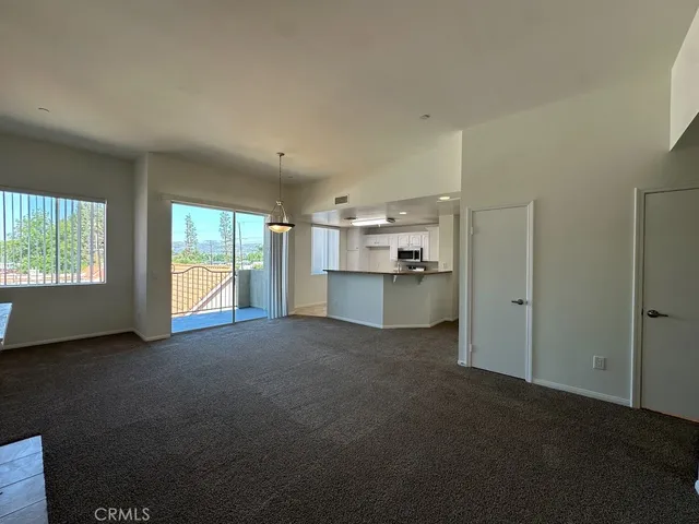 a view of a kitchen with a sink and a window