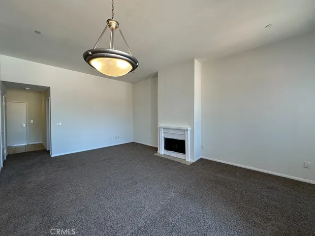 a view of empty room with a fireplace