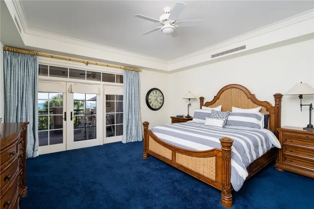 a bedroom with a bed and flat tv screen on dresser