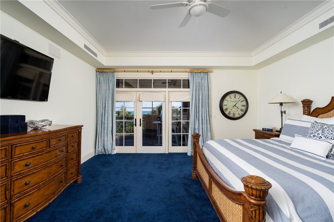 90 Beachside Drive, Unit 101 Vero Beach, FL 32963 - Photo 16 of 29 a bedroom with a bed and flat tv screen on dresser