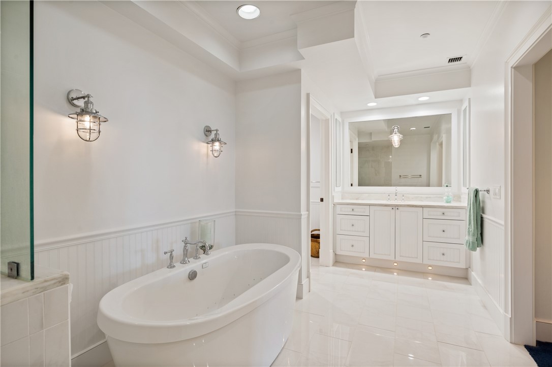 90 Beachside Drive, Unit 101 Vero Beach, FL 32963 - Photo 18 of 29 a bathroom with a bathtub sink and mirror