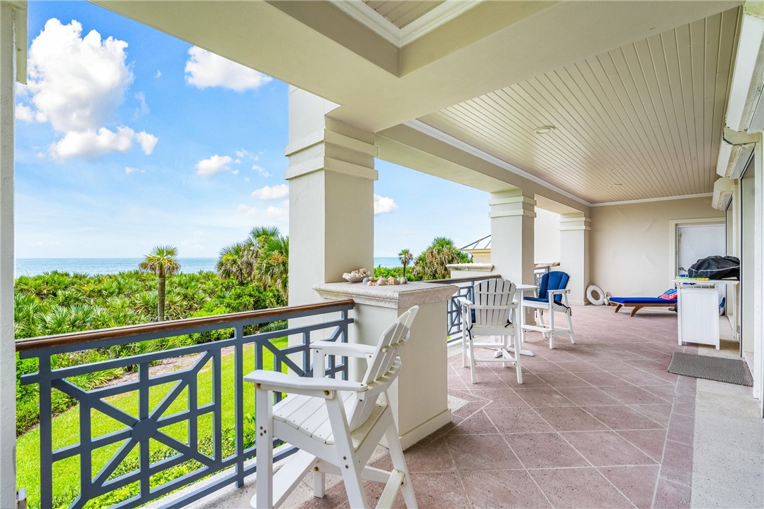90 Beachside Drive, Unit 101 Vero Beach, FL 32963 - Photo 20 of 29 a view of a patio with a table and chairs and potted plants