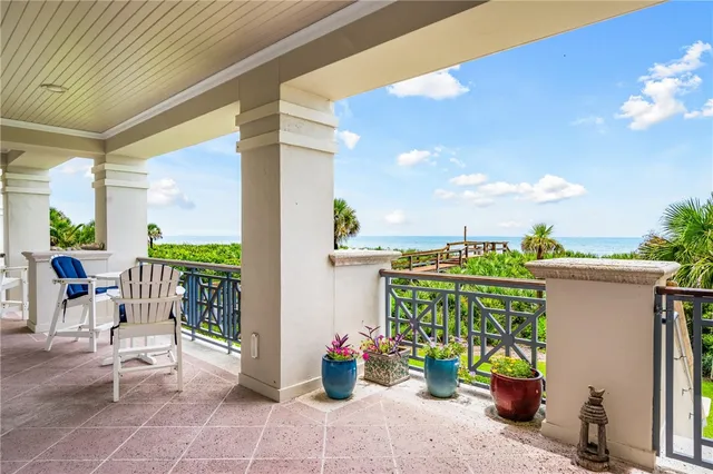 a view of a chairs and table in the balcony