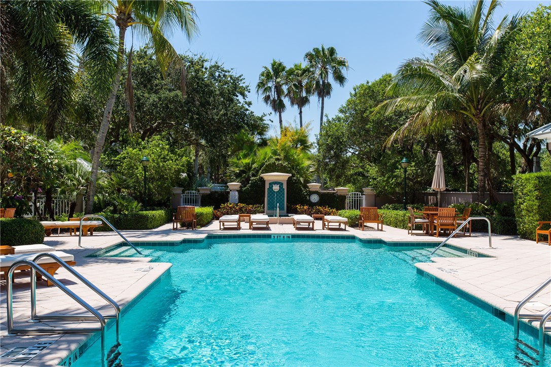 90 Beachside Drive, Unit 101 Vero Beach, FL 32963 - Photo 28 of 29 a view of a swimming pool with lounge chairs in patio