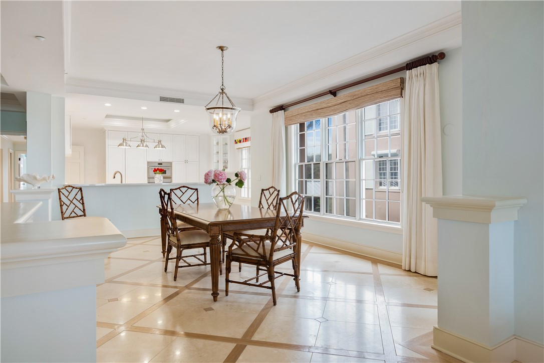 90 Beachside Drive, Unit 101 Vero Beach, FL 32963 - Photo 8 of 29 a dining room with furniture a chandelier and a rug