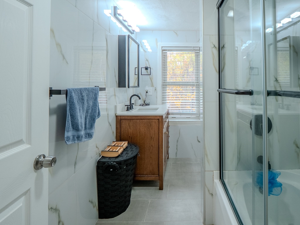 51 Lancaster Road Dedham, MA 02026 - Photo 20 of 41 a bathroom with a sink a toilet and shower
