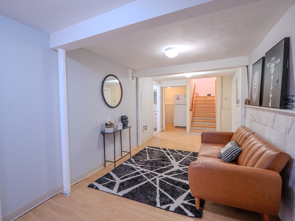 51 Lancaster Road Dedham, MA 02026 - Photo 29 of 41 a living room with furniture a rug and a window