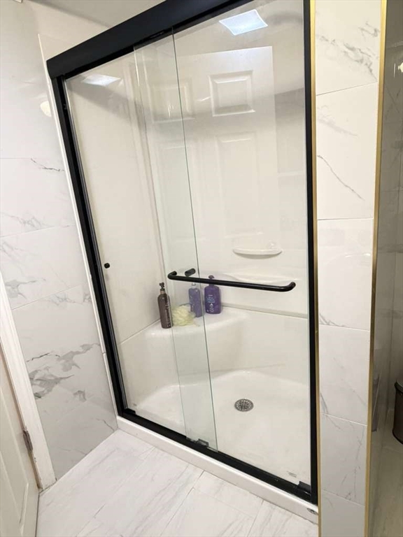 51 Lancaster Road Dedham, MA 02026 - Photo 38 of 41 a bathroom with a glass shower door