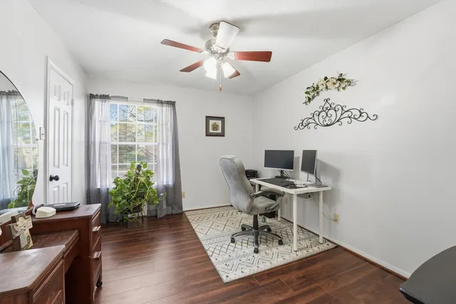 a workspace with furniture and a potted plant