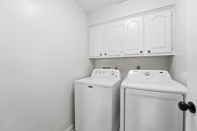a view of storage and utility room with washer and dryer