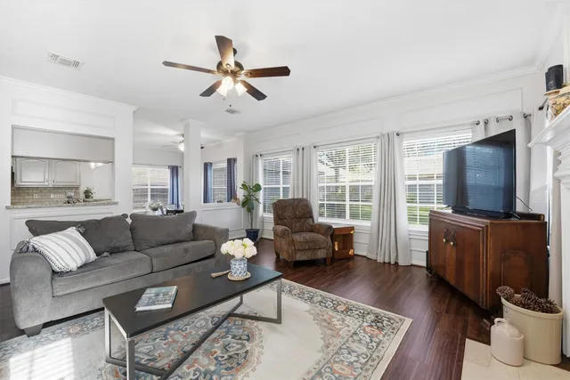 a living room with furniture flat screen tv and wooden floor