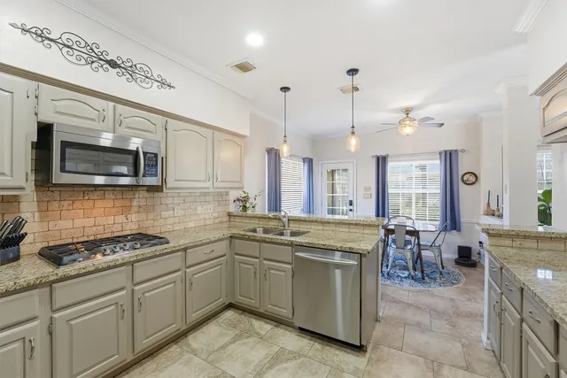 a kitchen with lots of counter top space appliances and cabinets