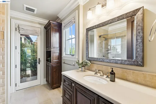 a bathroom with a shower sink and mirror
