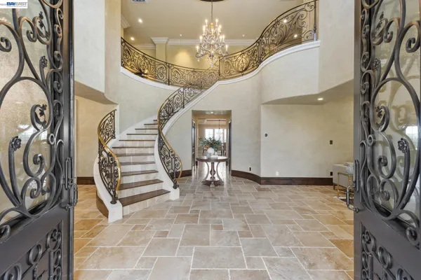 a view of a dining room with furniture and chandelier