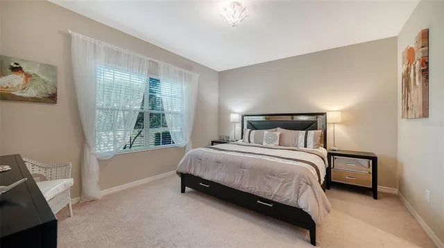 a bed sitting in a bedroom next to a window