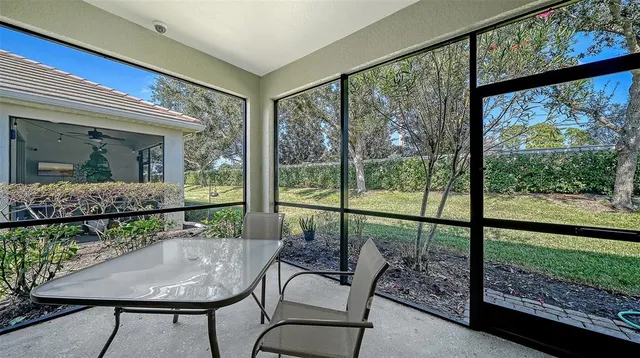 a view of a dining room with furniture large windows and wooden floor