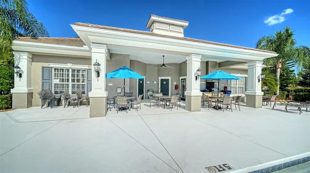 a view of two chairs and tables in a patio