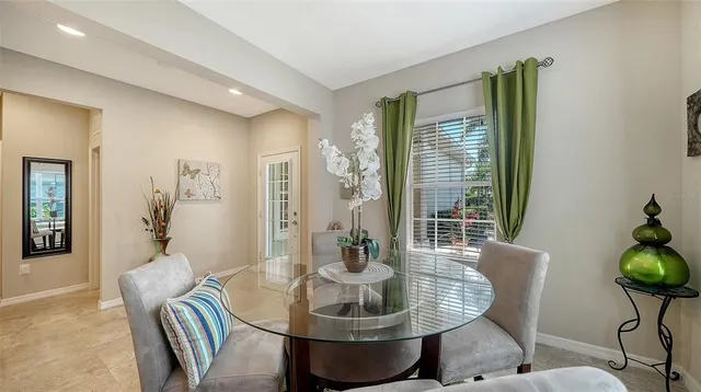 a dining room with furniture and window