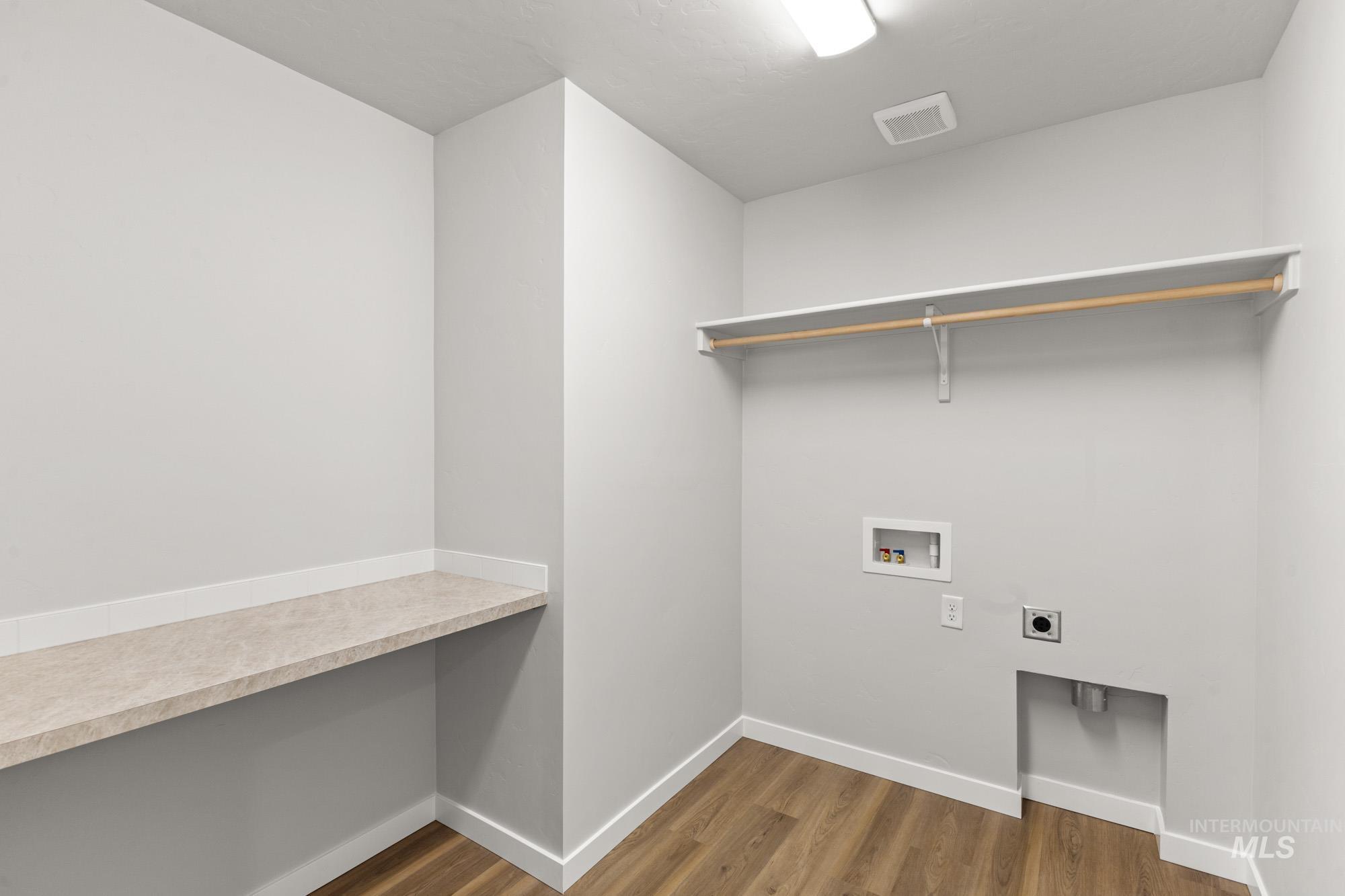 13713 Judson Street Caldwell, ID 83607 - Photo 16 of 24 Laundry area featuring dark wood finished floors, hookup for a washing machine, and hookup for an electric dryer
