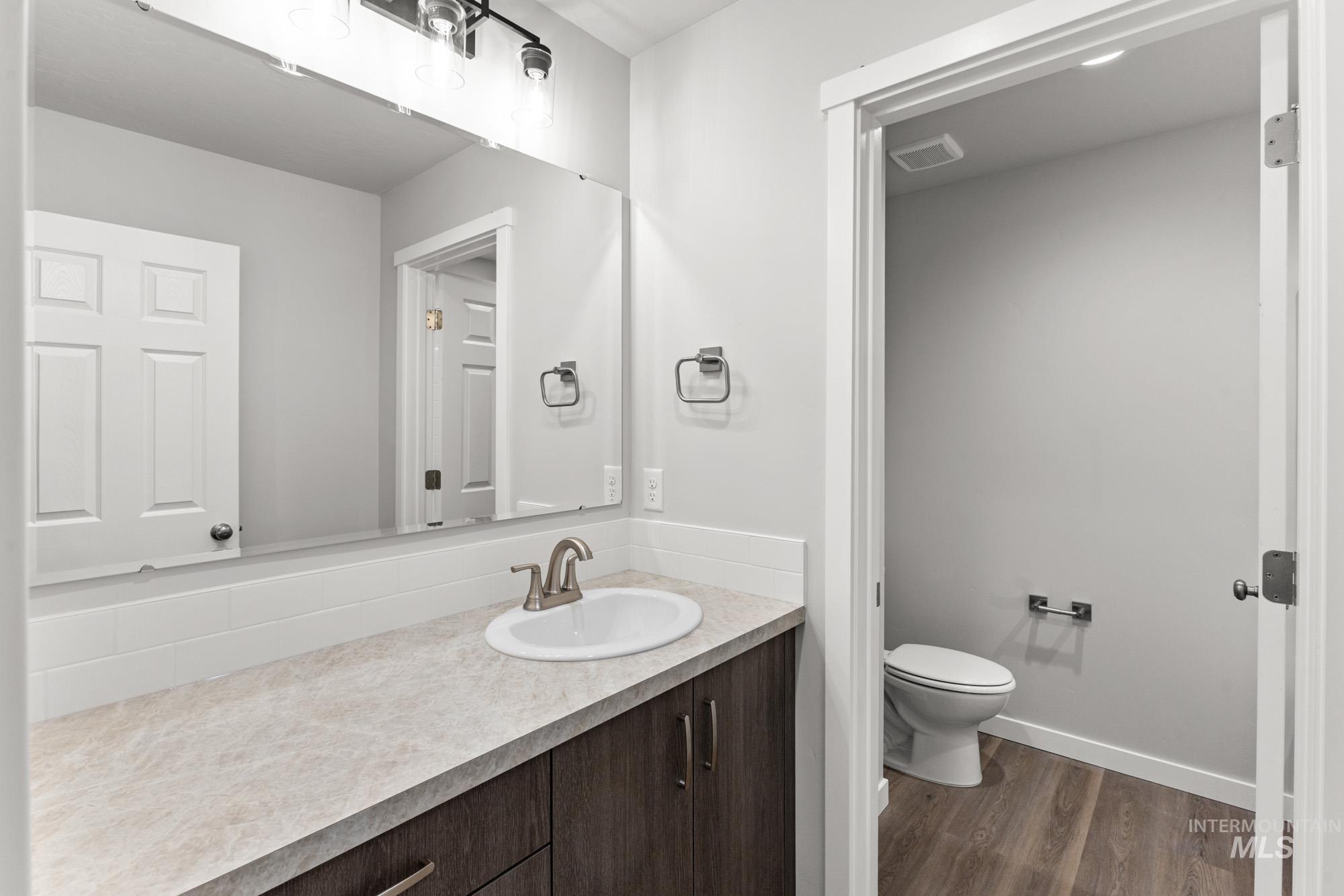 13713 Judson Street Caldwell, ID 83607 - Photo 17 of 24 Bathroom featuring vanity and dark wood finished floors