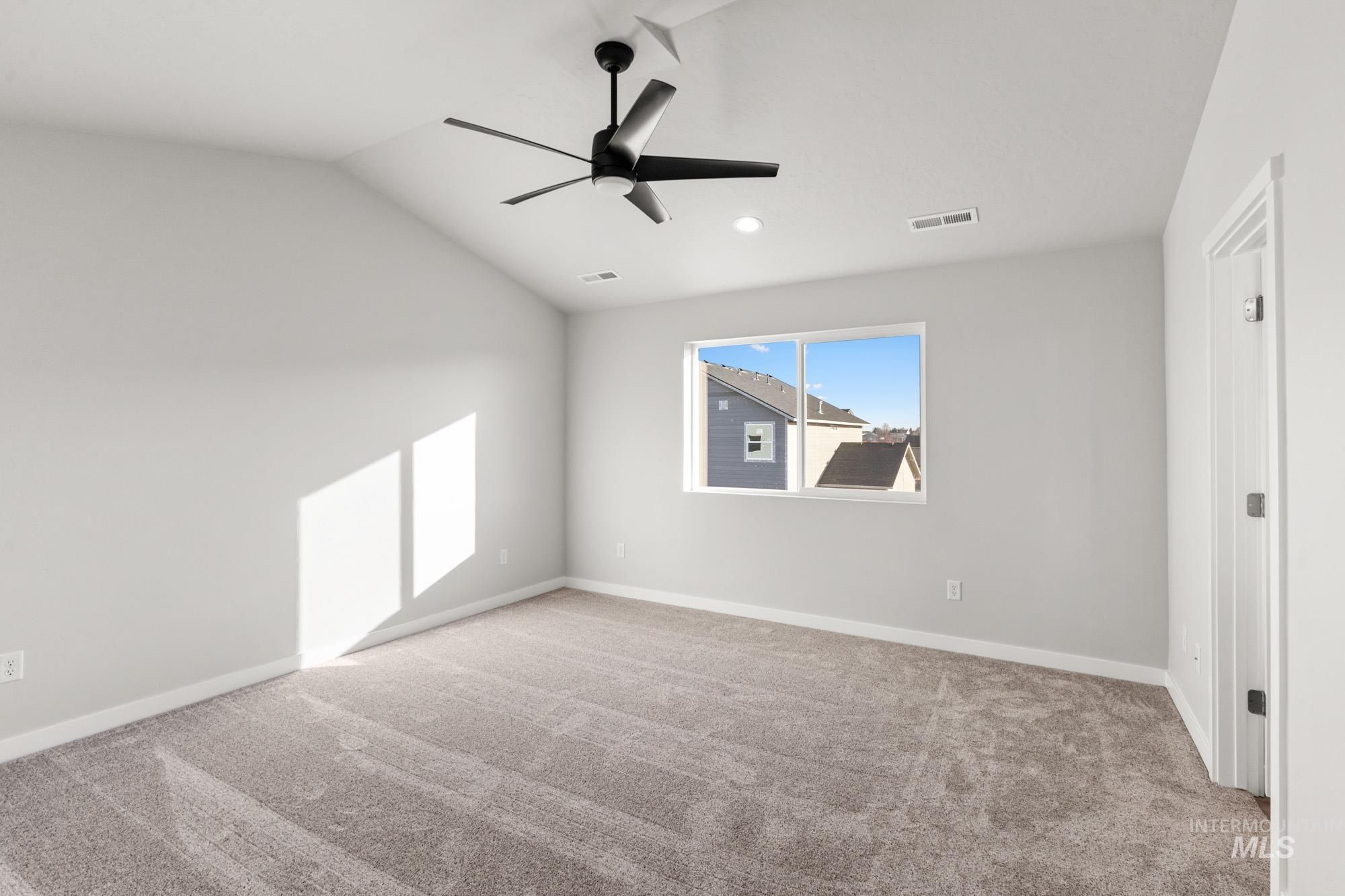 13713 Judson Street Caldwell, ID 83607 - Photo 18 of 24 Spare room featuring lofted ceiling, light colored carpet, and ceiling fan