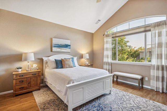 a bedroom with a bed and a large window with outer view