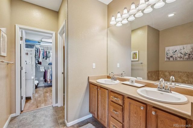 a bathroom with a sink double vanity and a mirror