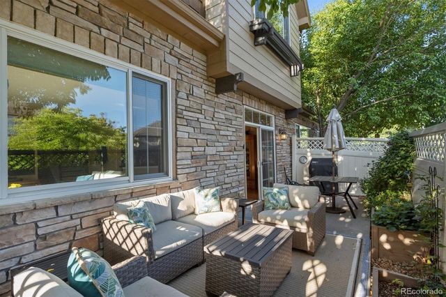 a view of a patio with couches table and chairs and potted plants