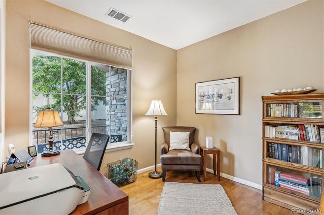 a living room with furniture and a book shelf