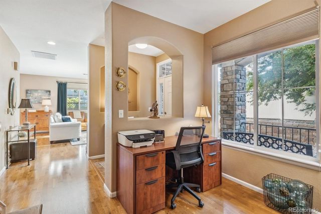 a very nice looking living room with a large window and kitchen view