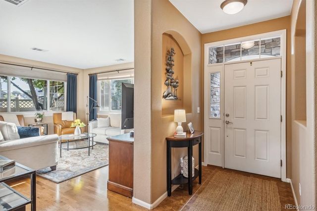 a view of living room filled with furniture and wooden floor