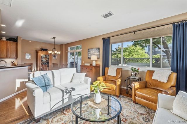 a living room with patio furniture and a large window