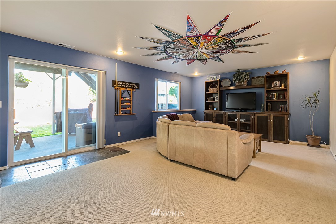 1392 McLeod Road Bellingham, WA 98226 - Photo 22 of 25 a living room with furniture a flat screen tv and a large window