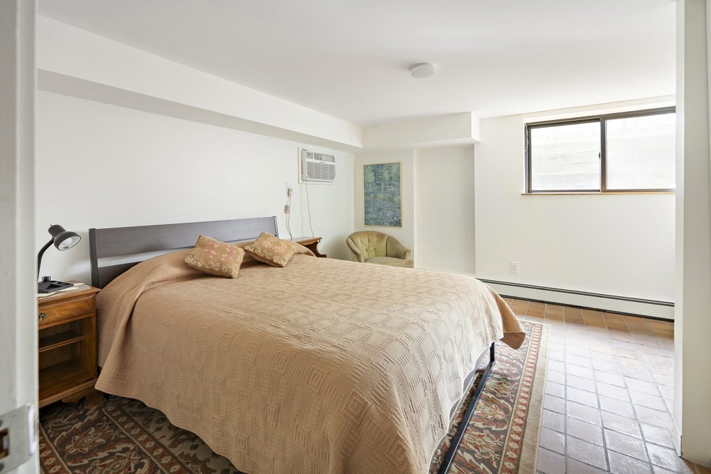 58 Garden Street, Unit F Cambridge, MA 02138 - Photo 18 of 25 a bedroom with a bed and wooden floor