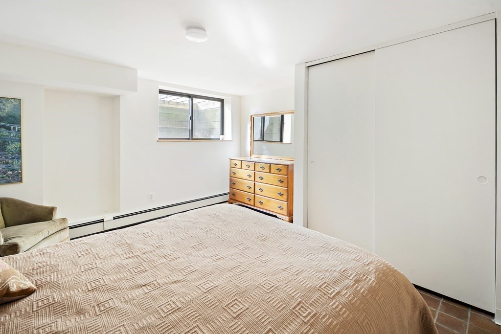 58 Garden Street, Unit F Cambridge, MA 02138 - Photo 19 of 25 a view of a bedroom with a bed and wooden floor