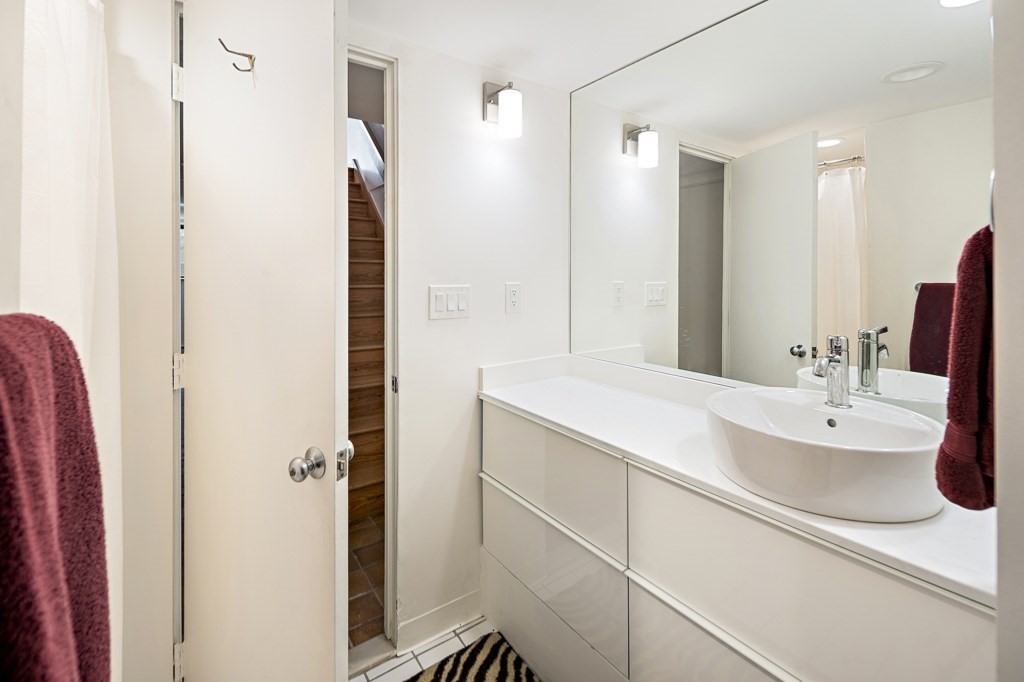 58 Garden Street, Unit F Cambridge, MA 02138 - Photo 21 of 25 a bathroom with a double vanity sink mirror and double