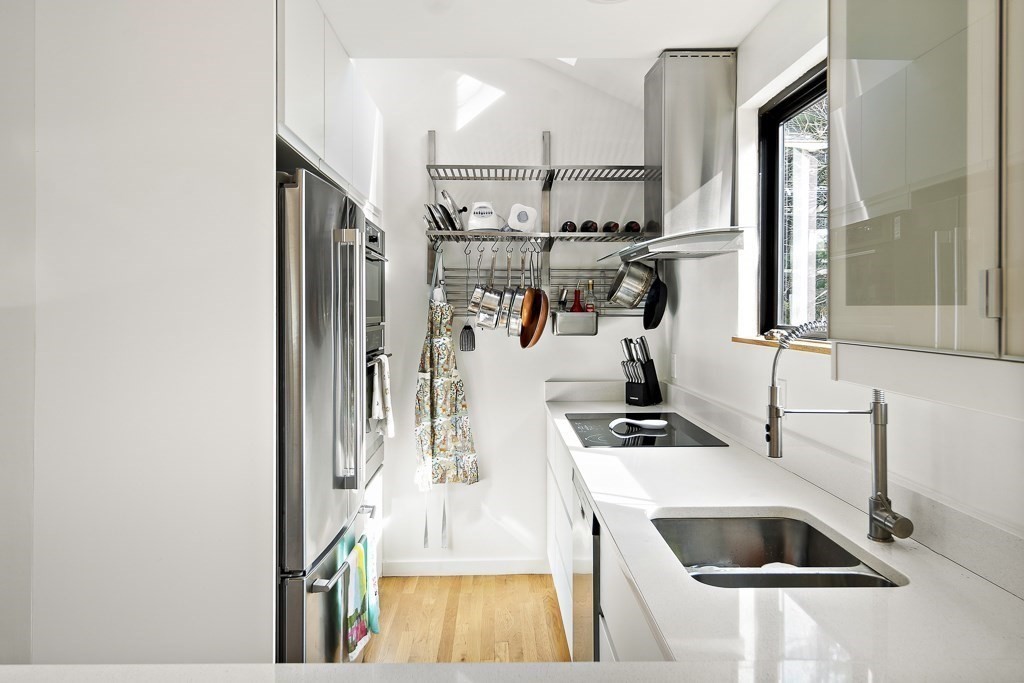 58 Garden Street, Unit F Cambridge, MA 02138 - Photo 6 of 25 a kitchen with stainless steel appliances granite countertop a sink and a refrigerator
